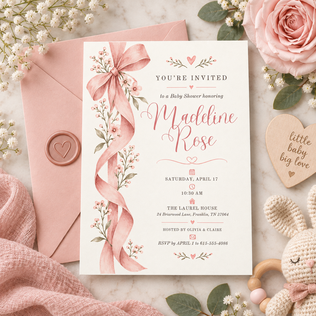 Pink bow baby shower invitation with a pink envelope and wax seal