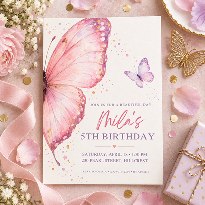 Pink butterfly wing invitation on pink linen with a gold butterfly and gift box