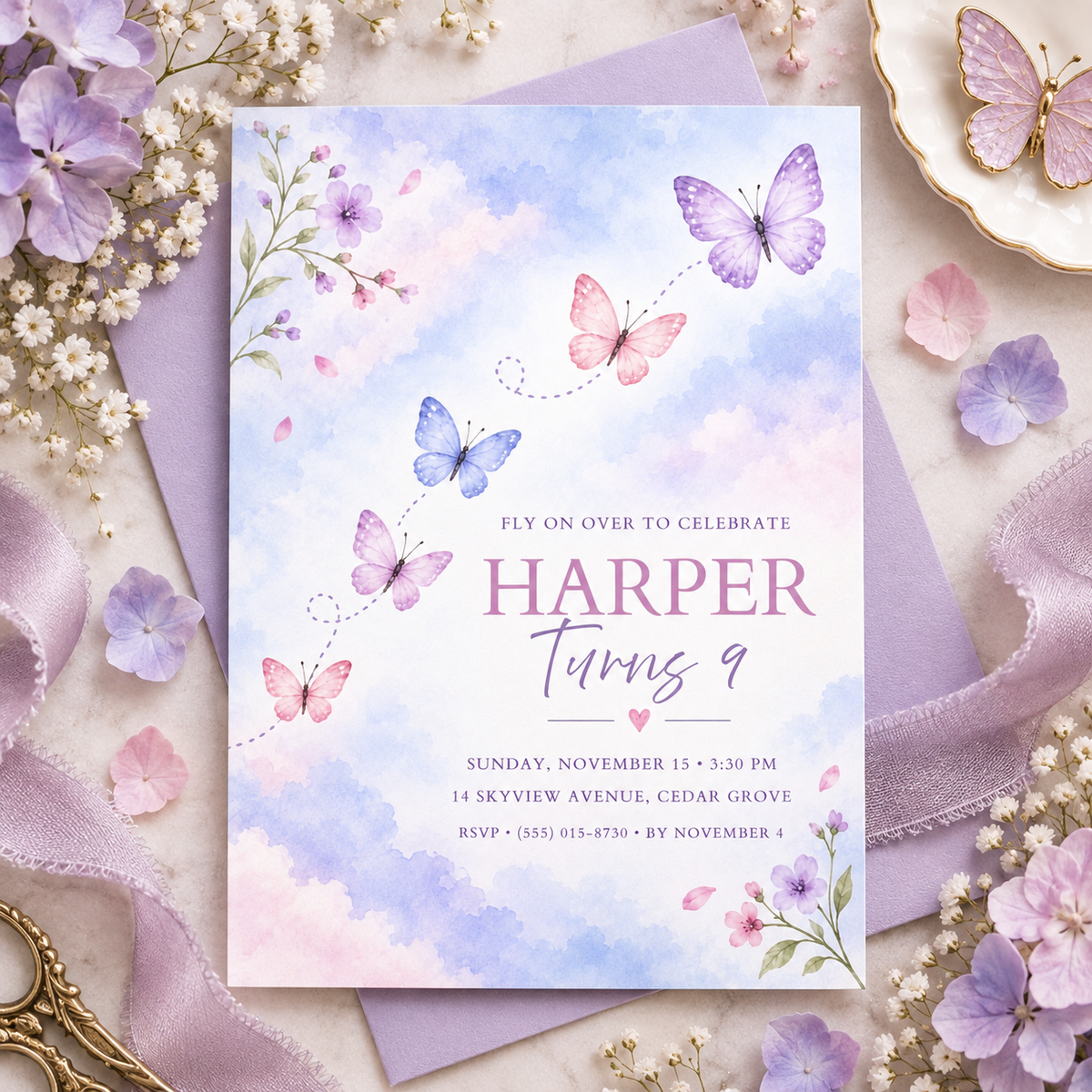 Fly on over butterfly invitation on a lilac envelope with lavender and pink petals
