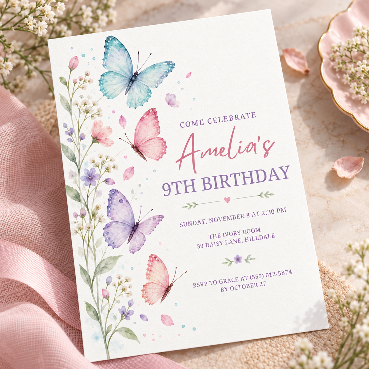 Pink and lavender wildflower invitation angled on white linen with petals