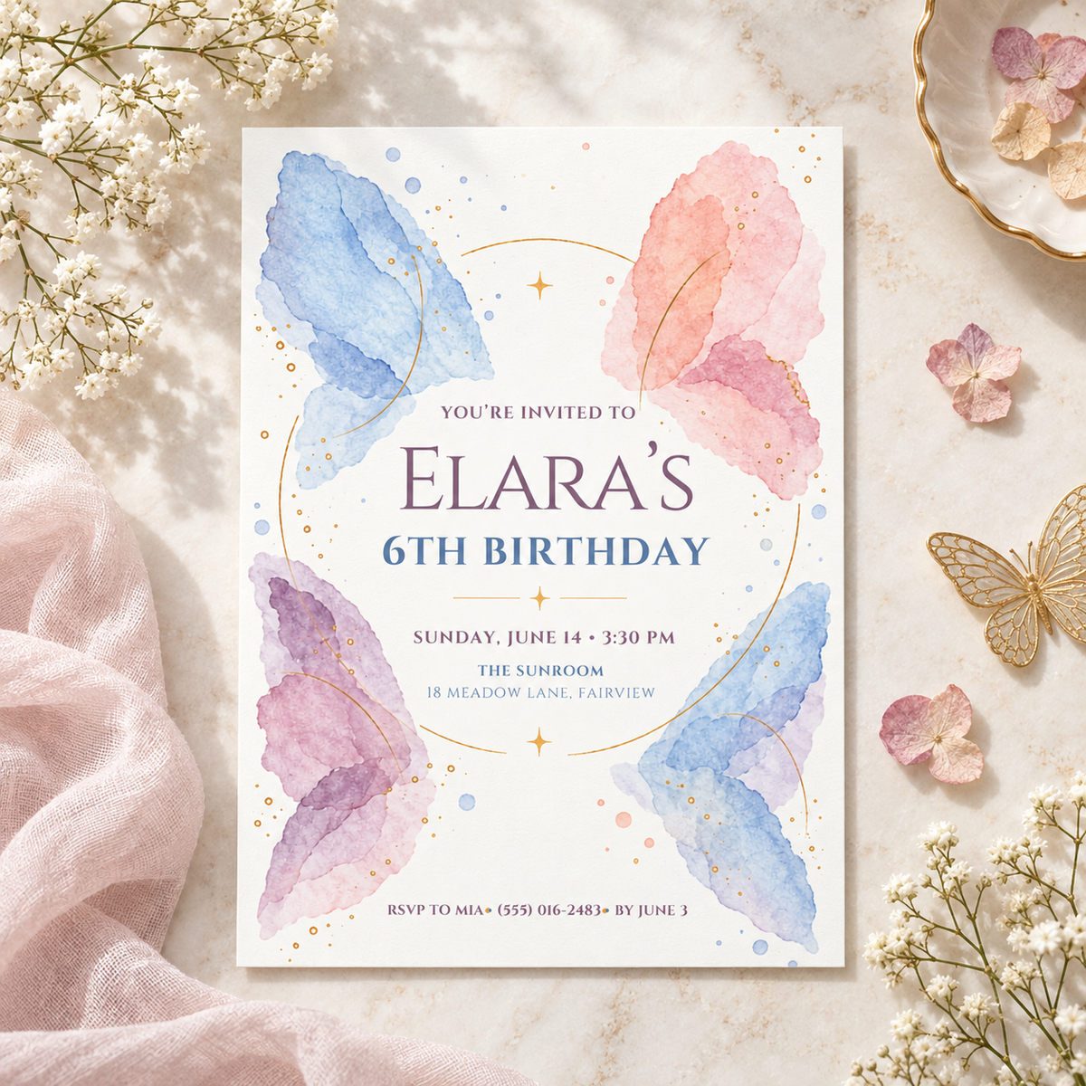 Butterfly wings birthday invitation on blush fabric with baby's breath